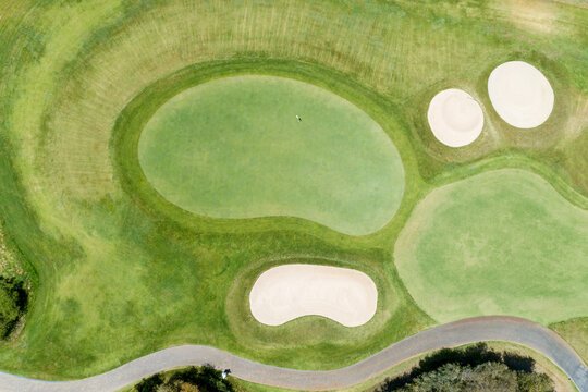 Aerial top down views of golf course greens, bunkers and fairway