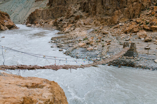 Suspension bridge over the mountain river