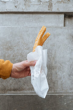Faceless person holding tasty ban in package