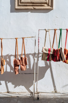 Bags hanging on guardrail at outdoor market
