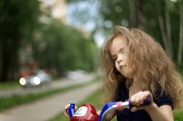 Portrait of a curly girl on a bike