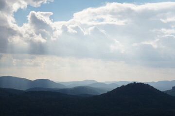 View from the Rötzenfels to the castle ruins of Lindelbrunn and the many hills of the Palatinate Forest