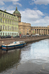 Fototapeta na wymiar tourist pleasure ship parked on the Griboyedov Canal in the historic center of St. Petersburg
