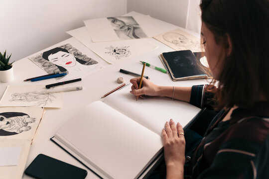Woman drawing on a notebook