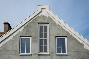 Design of the upper part of the gable of the house with three Windows.