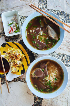 Portions of spicy soup with noodles
