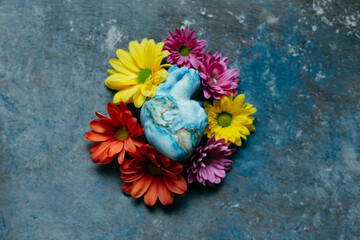 heart that represents the earth embraced by many flowers that refresh hope and the future.