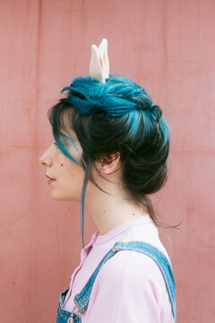 blue haired woman with rabbit ears .