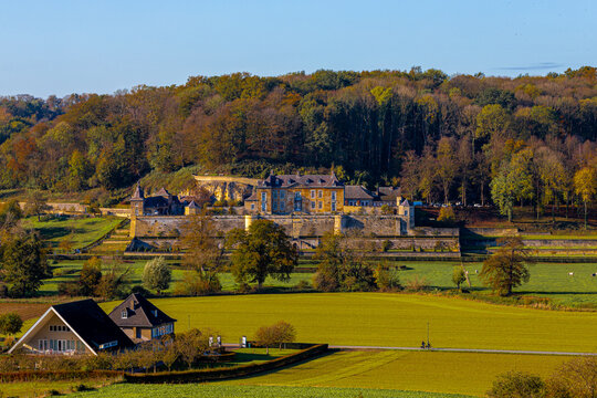 View over the Jekervallei (English Jeker Valley) near Maastricht with an amazing view over the nature turning into autumn with warm colors and the local castle in Neercanne currently a event venue