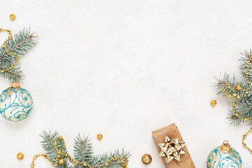 Christmas background with gift, green fir, New Year decorations on white table. Copy space, flat lay.