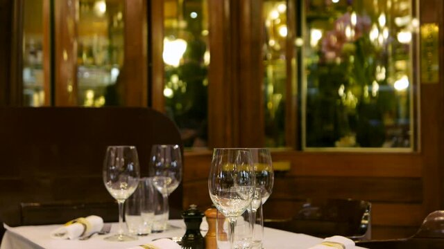Free table at the restaurant with busy staff in the blurry background
