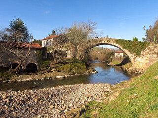 The stone bridge crossing the river from the town of Liérganes