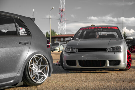 Moscow, Russia - July 19, 2019: Tuned low sport hatchback with red Candy colored alloy wheels. Golf mk 4 is on the street. Stanced lowrider with badboy hood