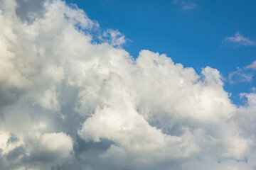 Background of white Cumulus clouds in a blue sky. The concept of weather and rain. Pre-storm state of nature. The natural background. Full frame with copy space