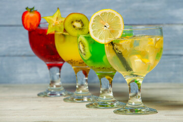 Cocktails and soft drinks. Fruit juice cocktail drink. assorted cocktail drinks. Different cold refreshing cocktails on wooden table