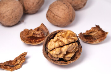 Walnuts isolated on white background. Walnut kernels and whole walnuts