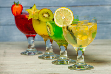 Cocktails and soft drinks. Fruit juice cocktail drink. assorted cocktail drinks. Different cold refreshing cocktails on wooden table