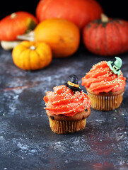 halloween cupcake and pumpkin on a dark background. sweets with cupcakes for the celebration of spooky Halloween.