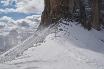 wall of a peak of laveredo are distinctive battlement, 3 zinnen with strong snow winds, blizzard