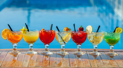 Cocktails and soft drinks. Fruit juice cocktail drink. assorted cocktail drinks. Different cold refreshing cocktails on wooden table