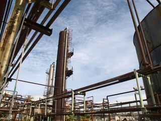 View of old rusty oil and petrochemical industrial refinery pipes. 