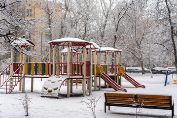 Colorful playground in snow. Winter old fashioned courtyard in Moscow Russia.