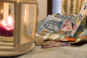 Money in coins and banknotes from different countries on denim