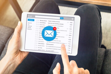 Email inbox notification with woman receiving new incoming message at home on digital tablet computer, e-mail communication marketing concept - obrazy, fototapety, plakaty