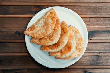 one portion ciborek in plate on wooden table