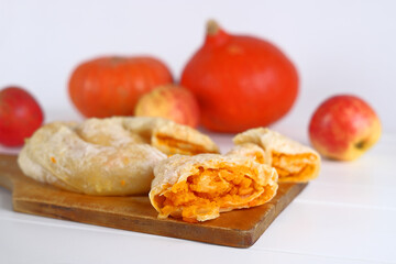 Pumpkin pie on a background of pumpkins