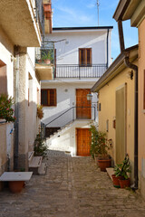 A narrow street among the old houses of di Pietrelcina, a medieval village in the Campania region, Italy.