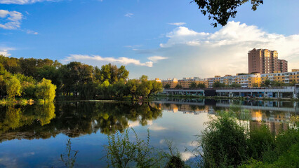 A pond in the city with business buildings on the side