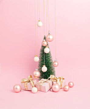 Christmas tree with ornaments over pink background. Minimal picture for winter holidays