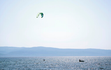 Tourists enjoying kite sports during a windy sunny day in Omis Resort, Croatia, Europe