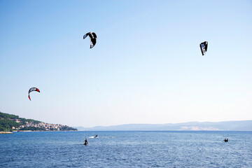 Tourists enjoying kite sports during a windy sunny day in Omis Resort, Croatia, Europe
