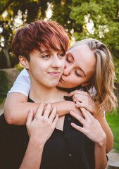 Girls couple in love hugging in a park on a sunny day.