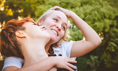 Girls couple in love hugging in a park on a sunny day.