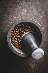 Roasted coffee beans in mortar