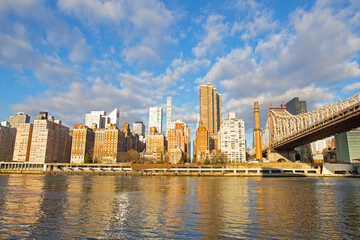 New York City skyline in the morning with sun beaming into windows of Manhattan buildings, USA.