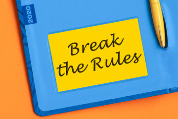 Break the rules the word is written in black letters on the yellow paper for notes.