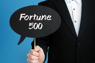 Fortune 500. Businessman holds speech bubble in his hand. Handwritten Word/Text on sign.