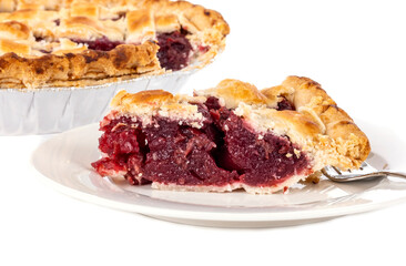 A Slice of Cooked Cherry Pie on a White Porcelain Plate with a Fork Isolated on White Background