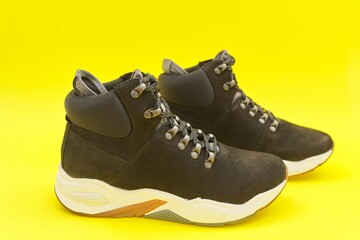 New womens leather black waterproof hiking winter autumn boots on yellow background