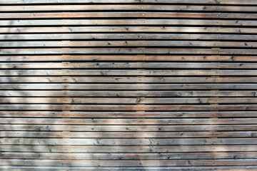 Facade pattern with wooden formwork of an apartment building in the city, residential home with sustainable materials and low energy concept