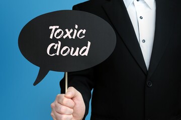 Toxic Cloud. Businessman holds speech bubble in his hand. Handwritten Word/Text on sign.