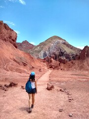 Fototapeta na wymiar Girl - Yerbas Buenas, Valle del Arcoiris - Rainbow Valley, San Pedro de Atacama, Chile. Beautiful and colorful mountains in the Atacama desert, one of the driest places in the world. 