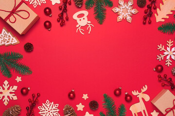 Fototapeta na wymiar Christmas frame with decorations on red background