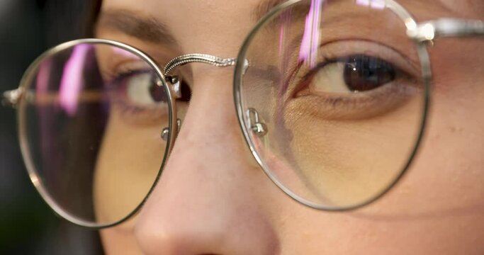 Close up of attractive woman with brown eyes in eyeglasses smiling and looking at camera. Health care and protection for vision. Natural female beauty.