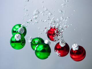 christmas baubles falling in the water with bubbles
