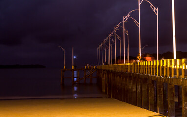 
sea ​​pier at night with dark sky